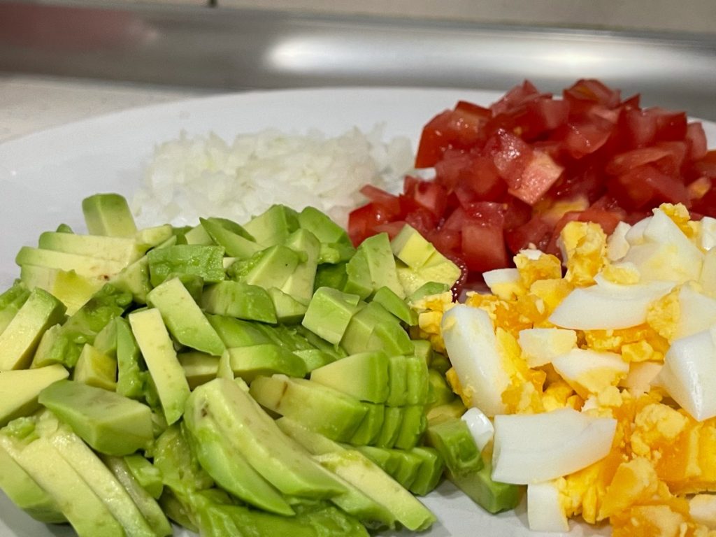 Picar el huevo, tomate, cebolla y aguacate